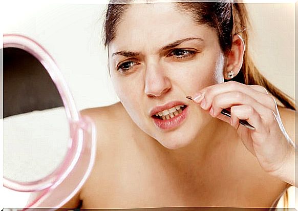 Woman waxing her upper lip