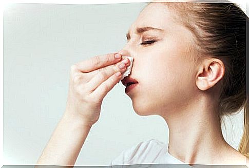 Woman with handkerchief on her nose