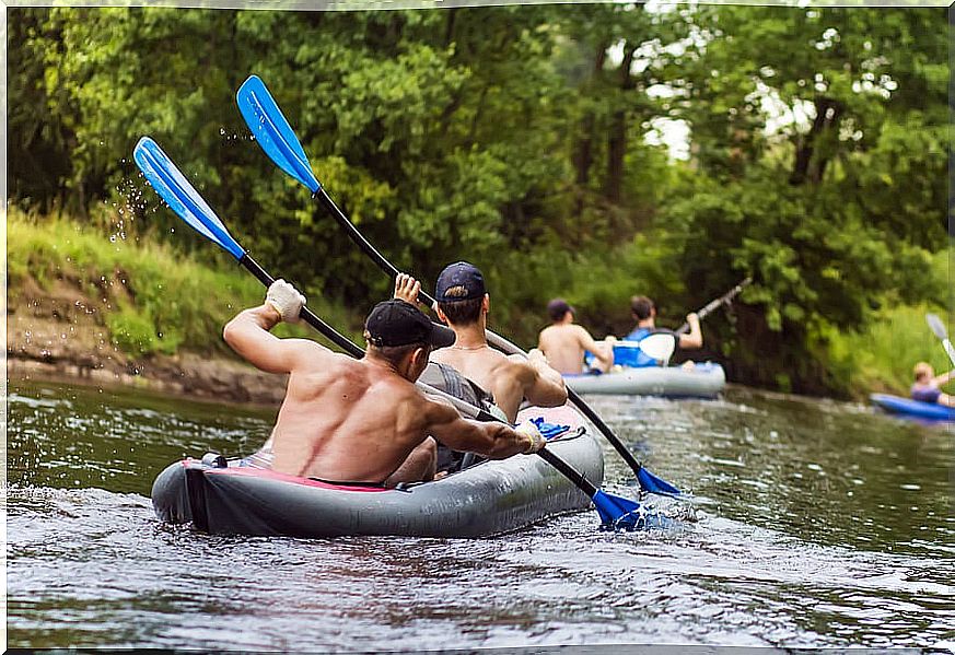 Group of boys paddling in pairs