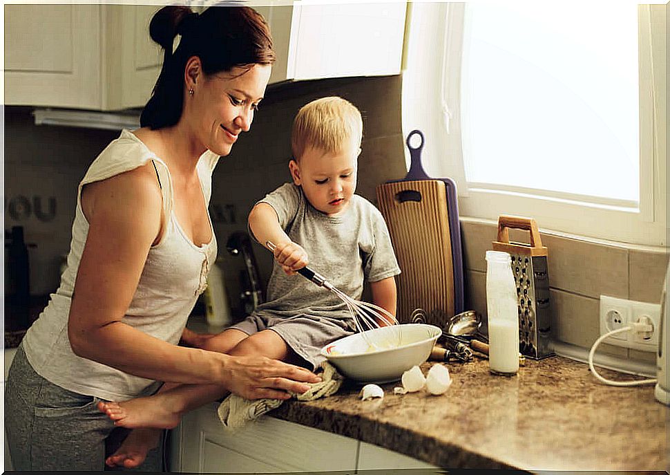 Mother cooking with her baby