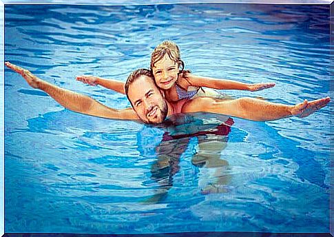 Father and daughter in the pool