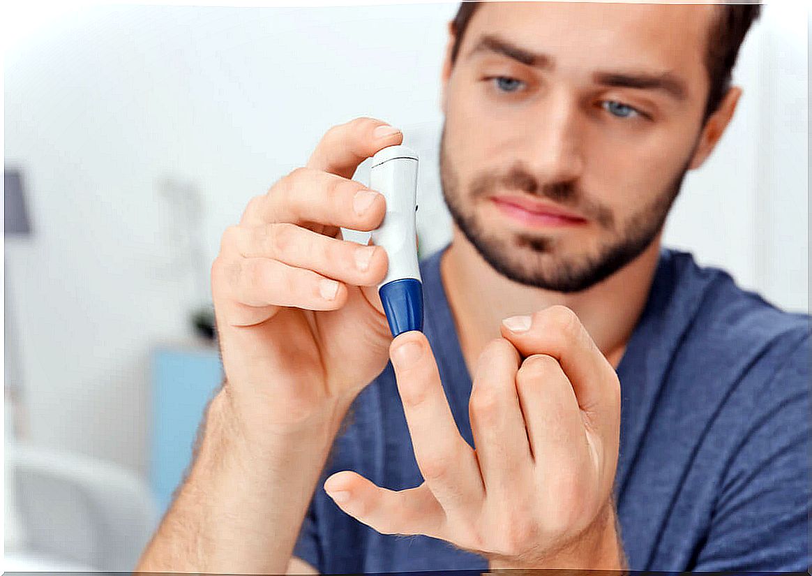 Man with diabetes measures his blood glucose.