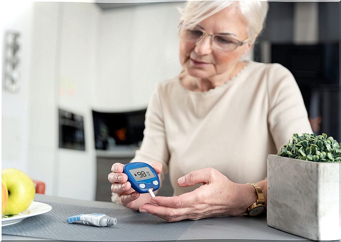 Woman measures her blood glucose