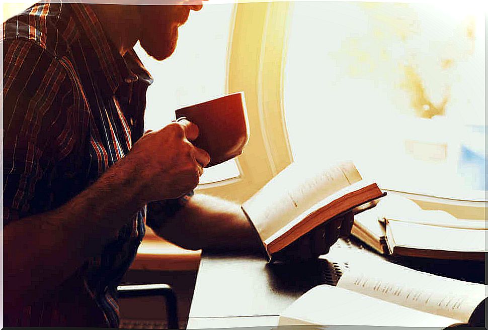 Man reading and drinking coffee.